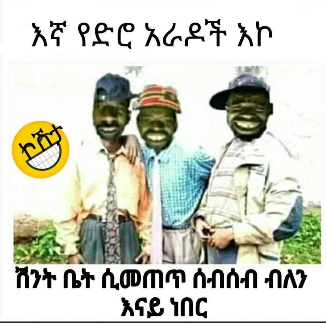 two men in front of a white wall with a smiley face